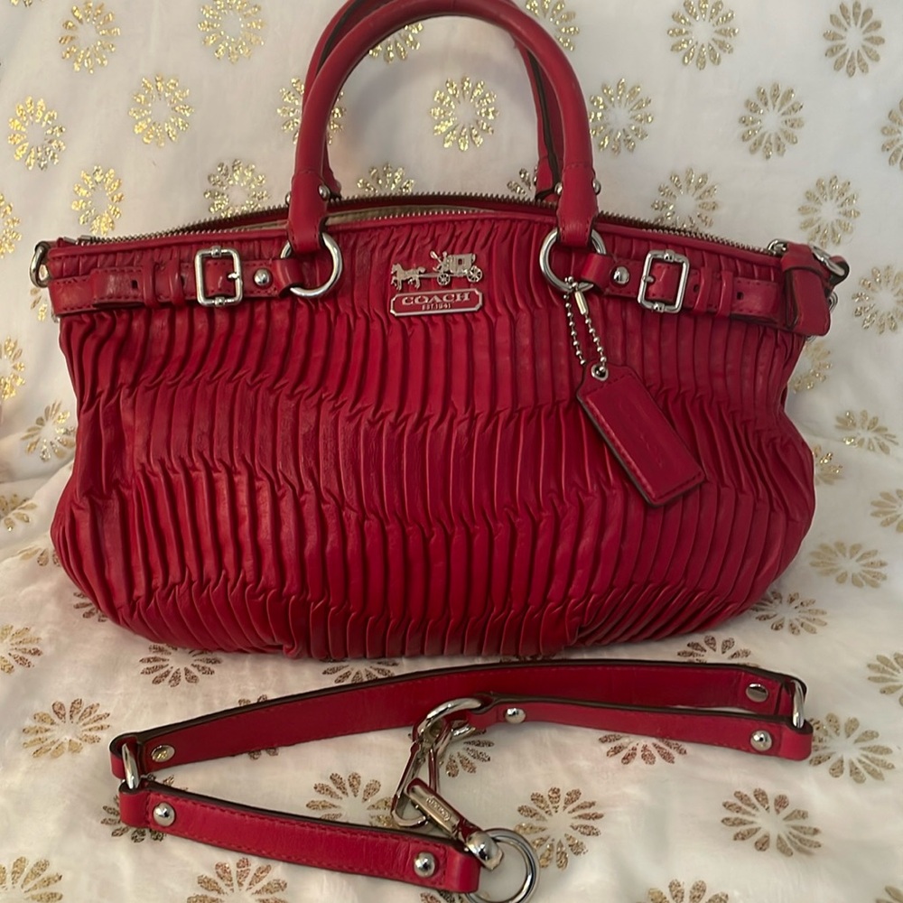 It’s called Burgundy, but looks like red. Rouched leather with silver hardware.